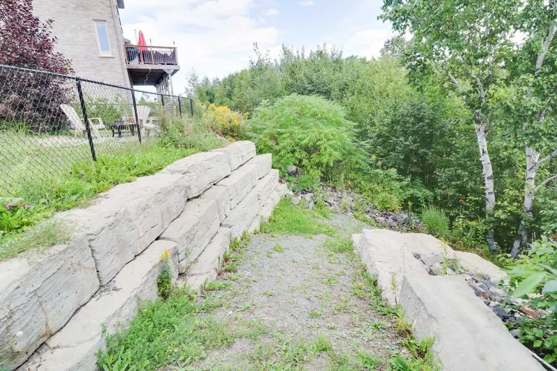 Aging concrete block retaining wall before the lakeside staircase was rebuilt