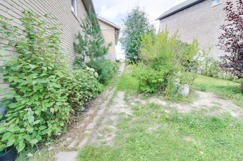 Worn dirt path along the side of the house before renovation