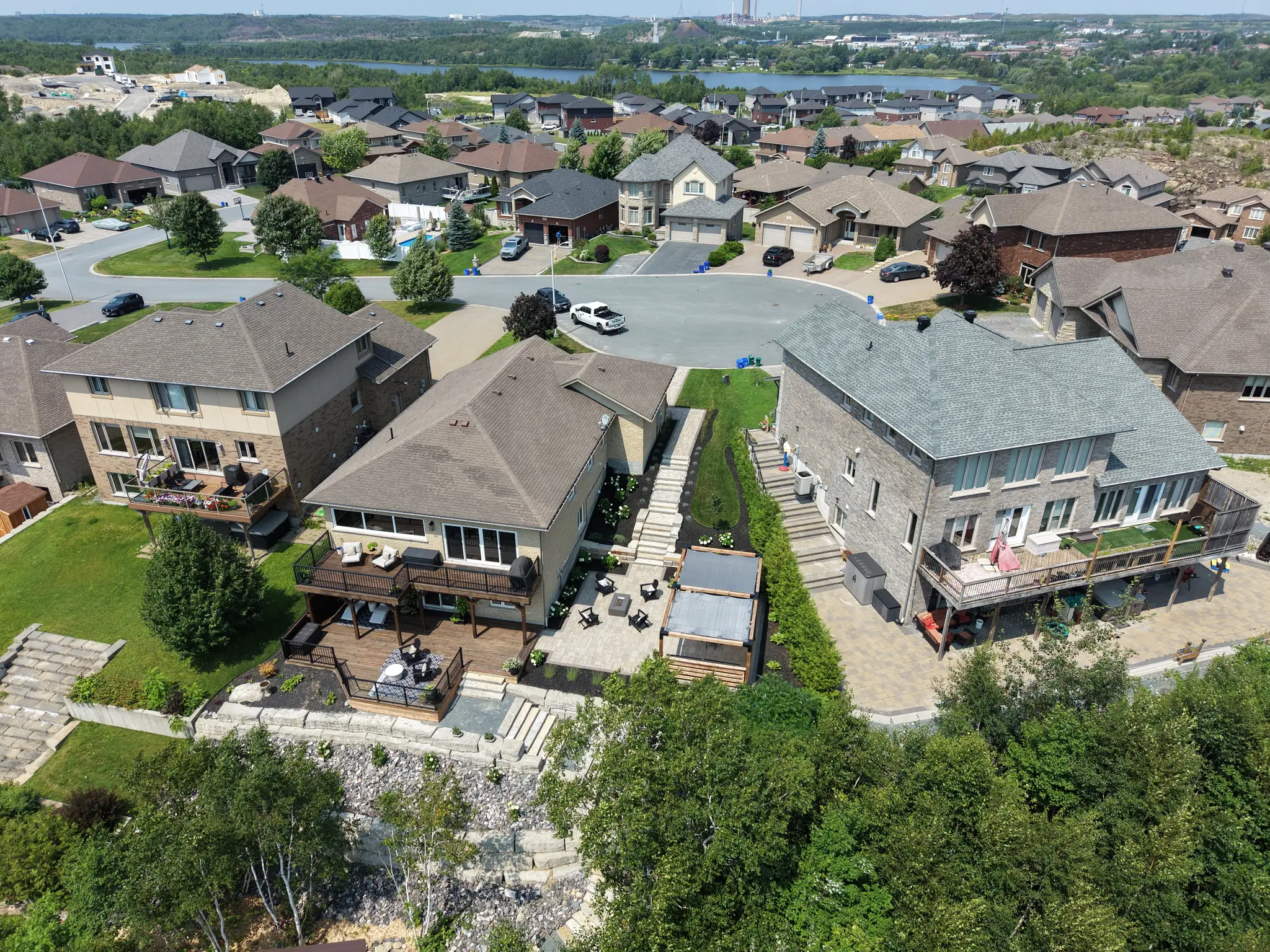 Aerial drone view of the Columba Terrace property, showing the house, lot and lake beyond
