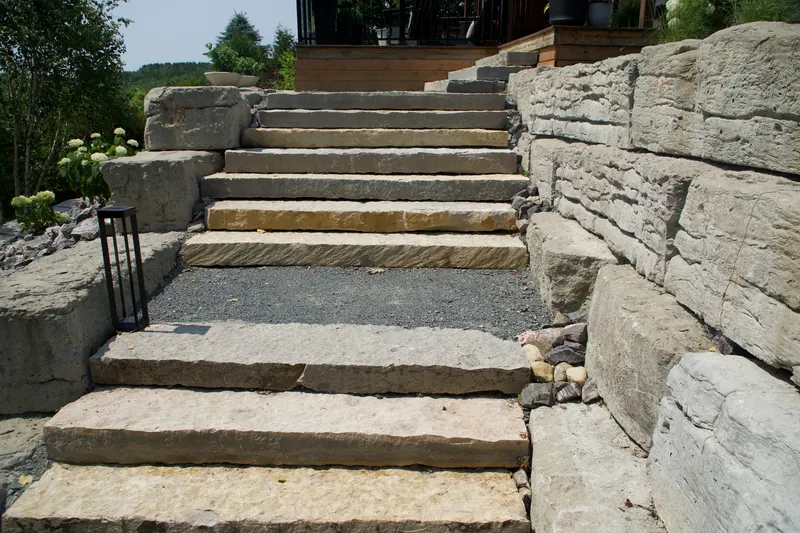 Finished curved natural stone staircase leading down to the dock