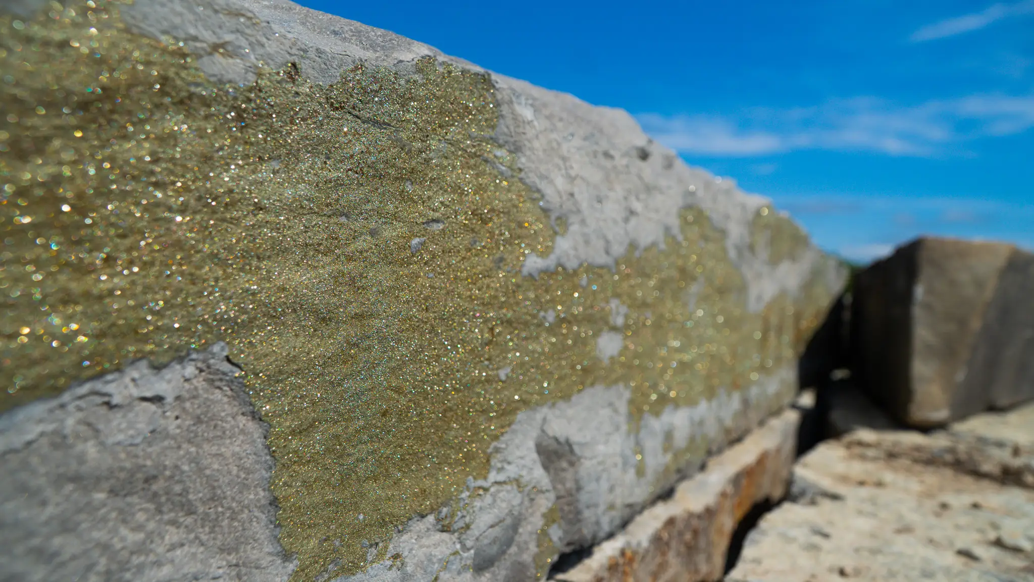 Close view of mineral-flecked stone against the sky at the Lime Kiln Quarry site in Ontario
