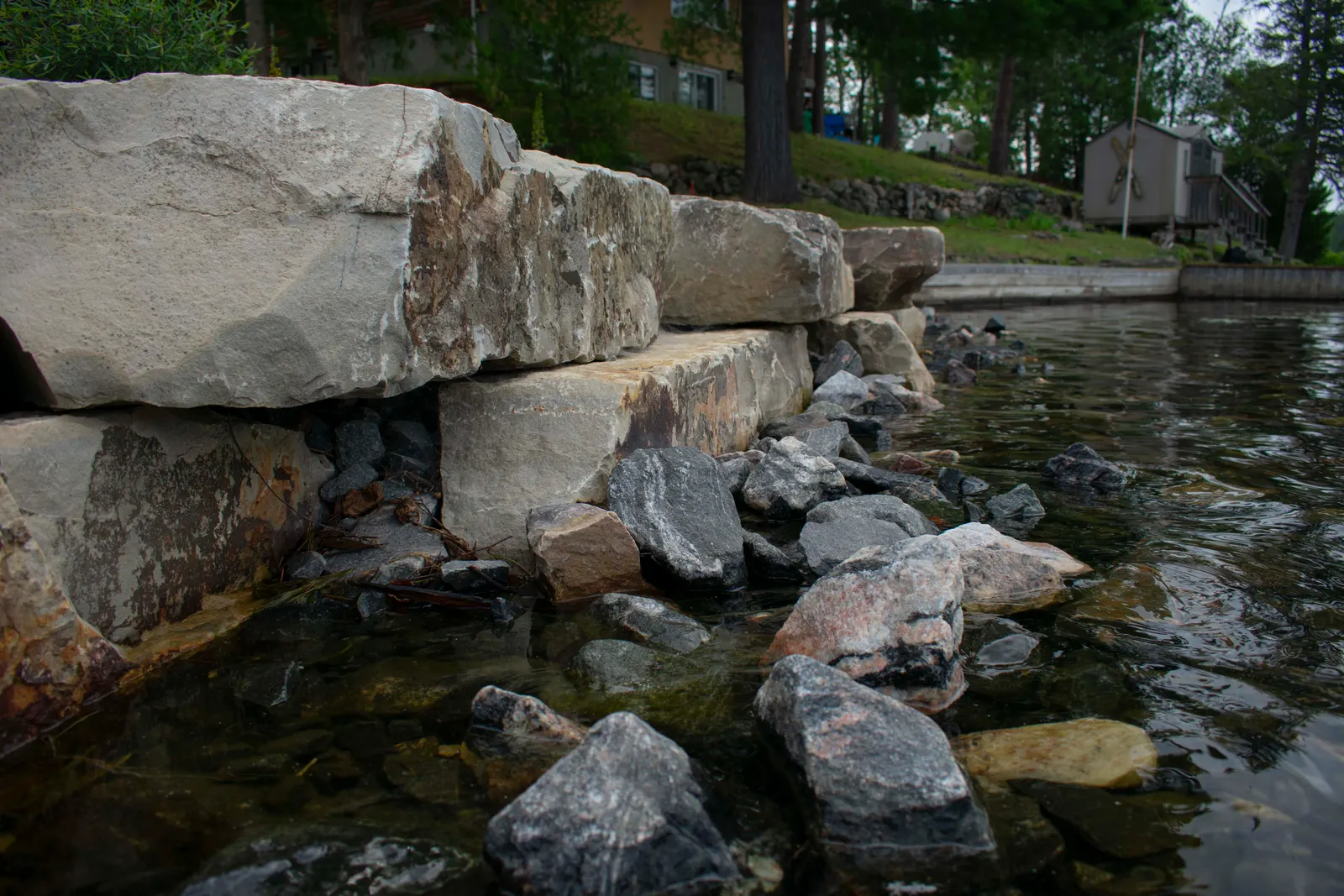 Armour stone shoreline retaining wall at the water's edge