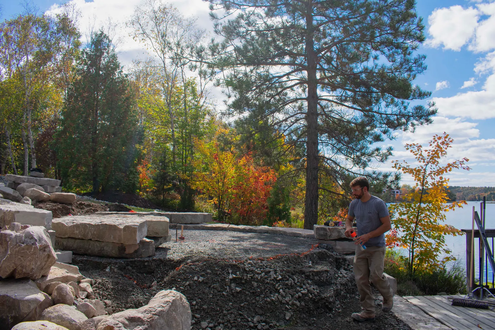Shoreline armour stone wall under construction in autumn