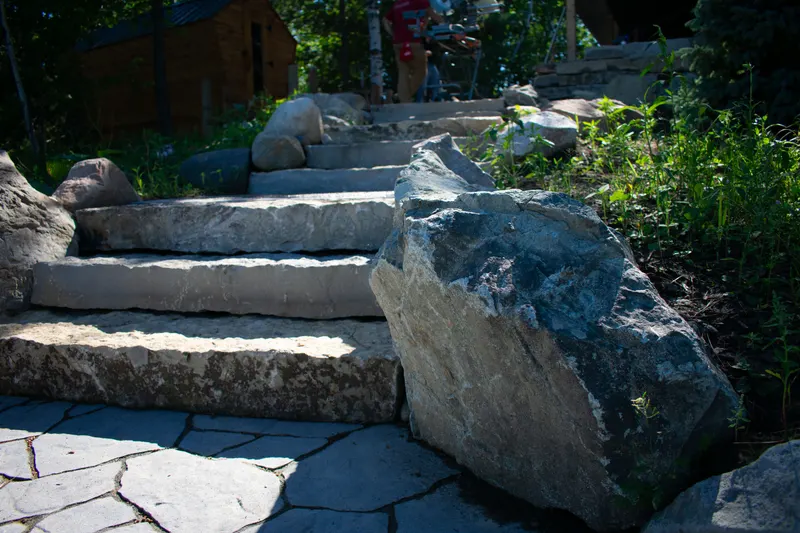 Natural stone steps built beside a large existing boulder